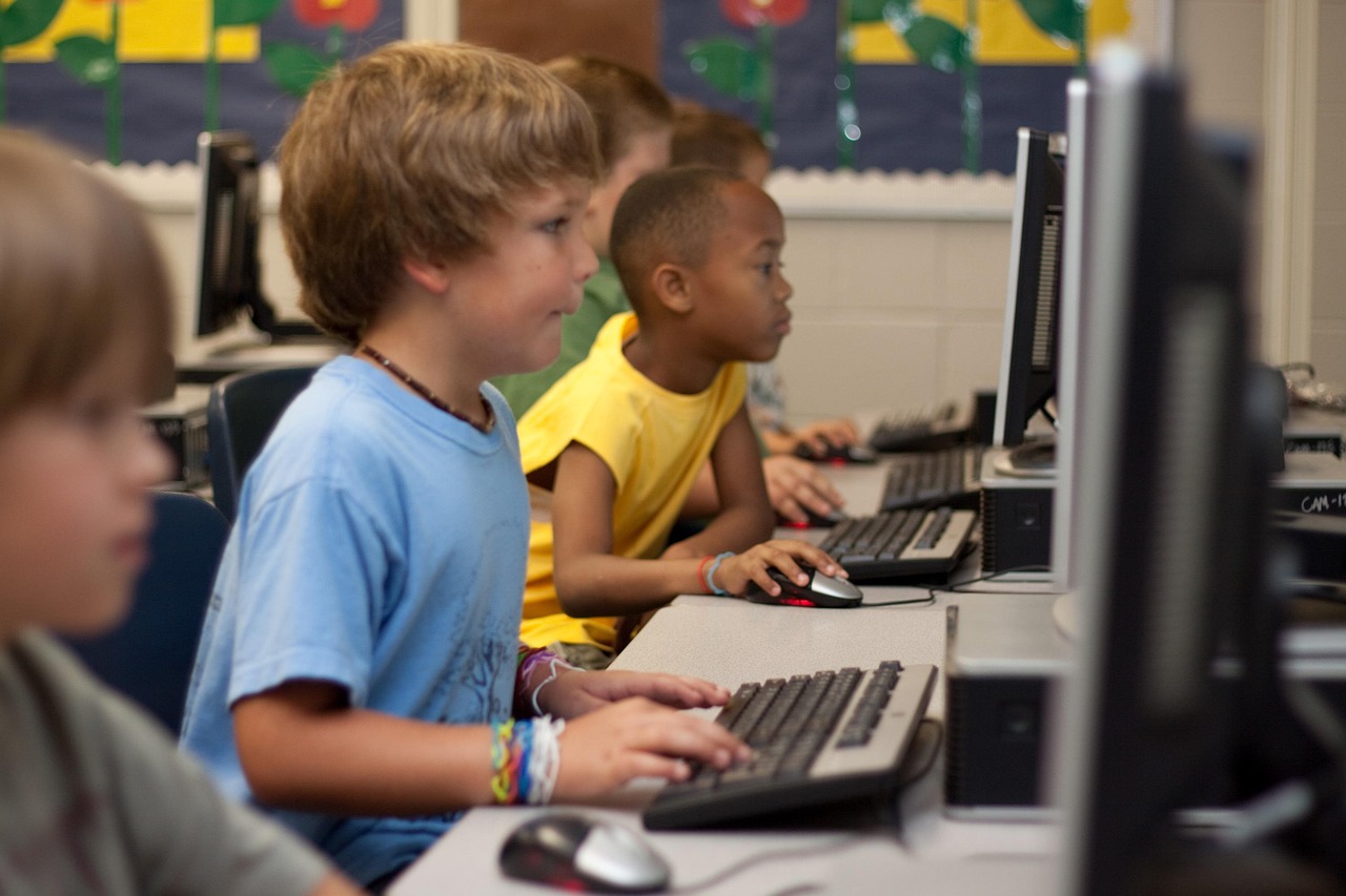 Diverse children using computers in a classroom